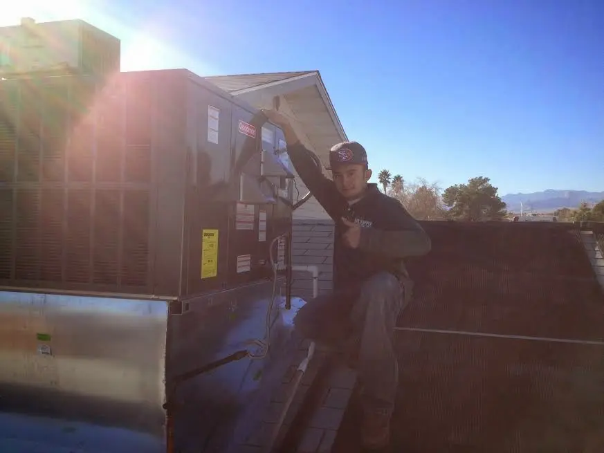 HVAC technician performing HVAC Inspection on a rooftop unit in Greenville